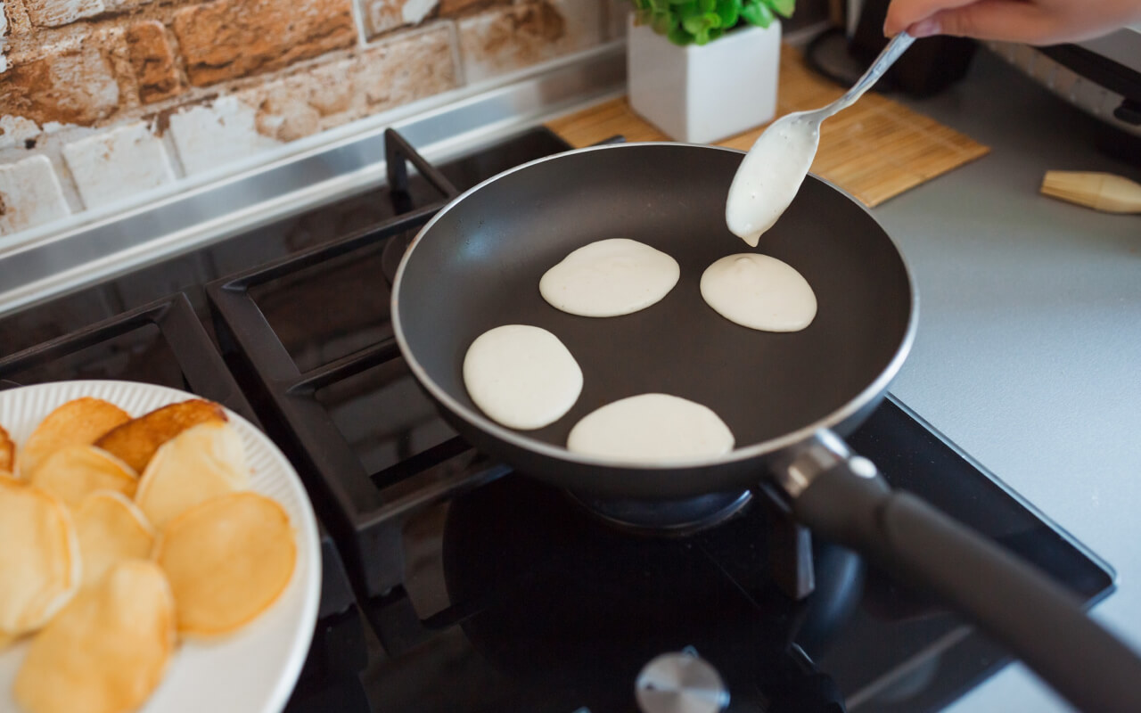 pouring small portions of the batter onto the grill